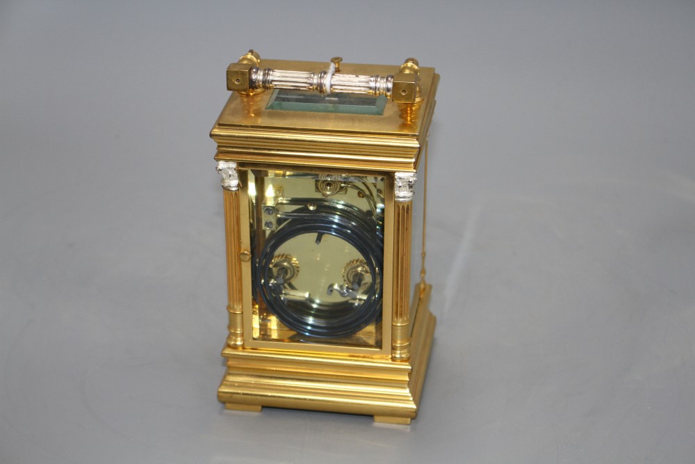 A 20th century silvered and gilt quarter repeating carriage clock